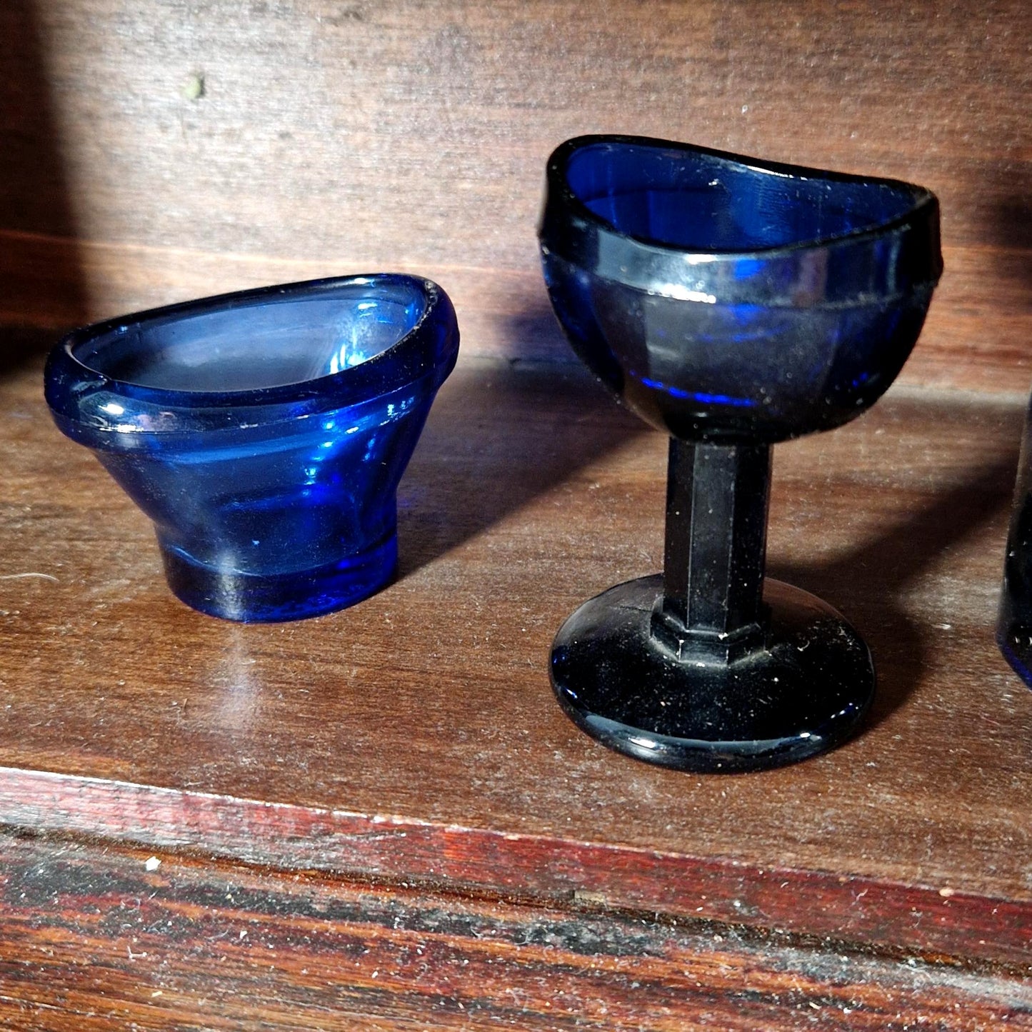 Collection of antique glass and porcelain eyewash stations