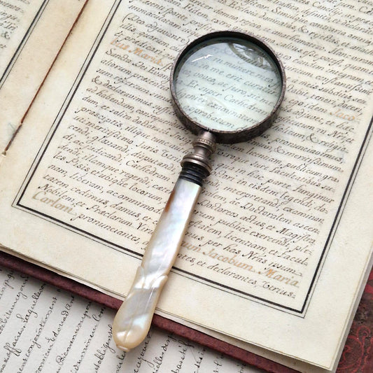Antique magnifying glass with carved mother-of-pearl handle