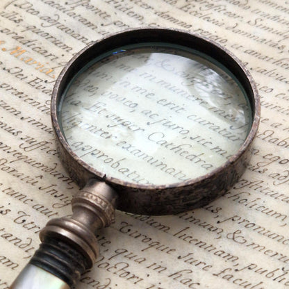 Antique magnifying glass with carved mother-of-pearl handle