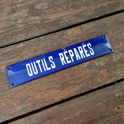 Blue enamel sign "Tools repaired"
