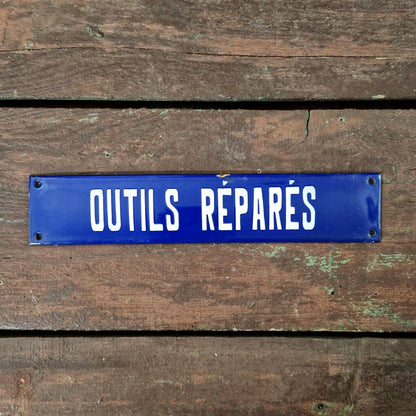 Blue enamel sign "Tools repaired"