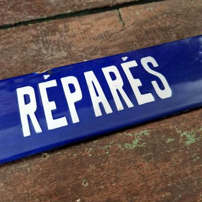Blue enamel sign "Tools repaired"
