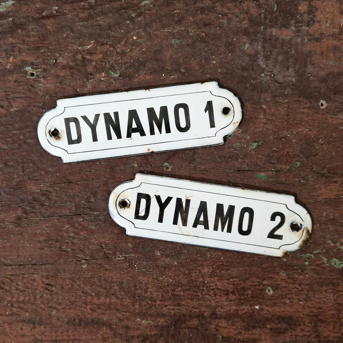 Two enamel signs reading "DYNAMO"