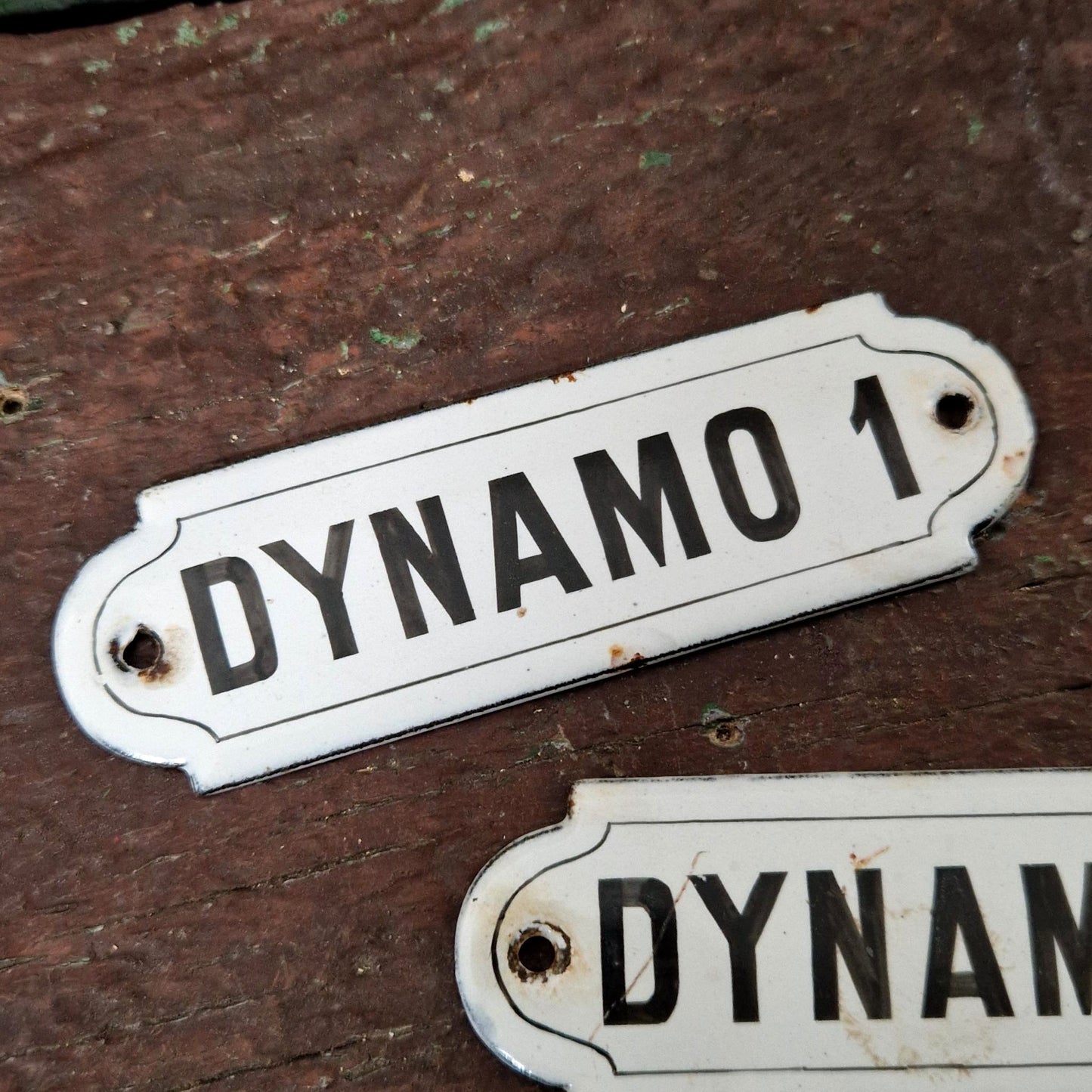 Two enamel signs reading "DYNAMO"