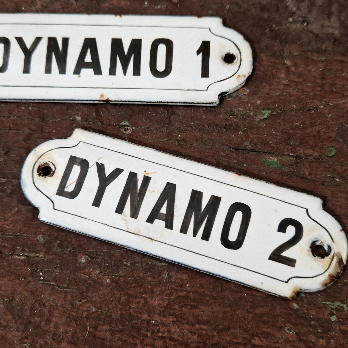 Two enamel signs reading "DYNAMO"