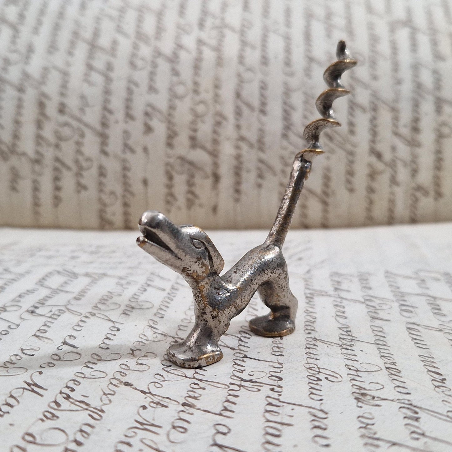Antique metal corkscrew with a dog motif
