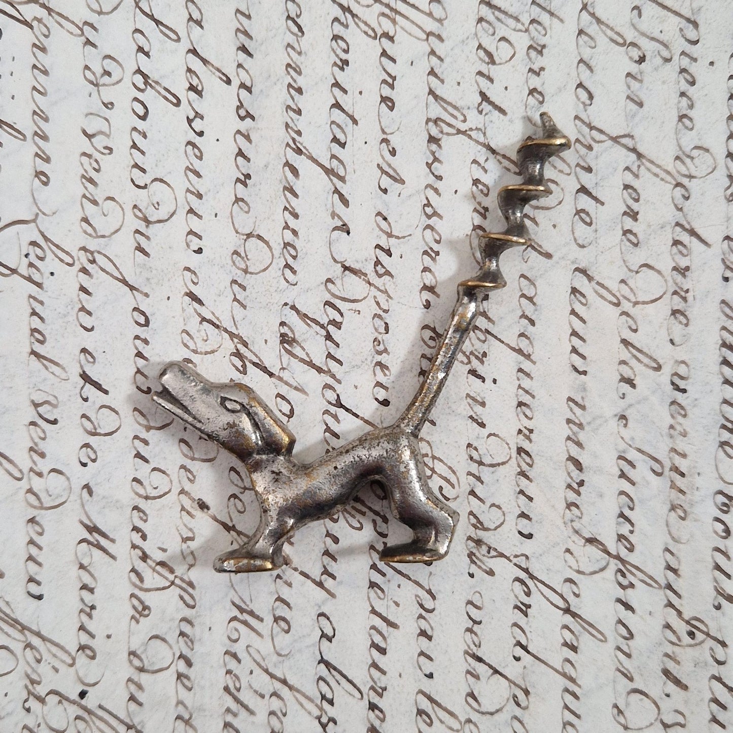 Antique metal corkscrew with a dog motif