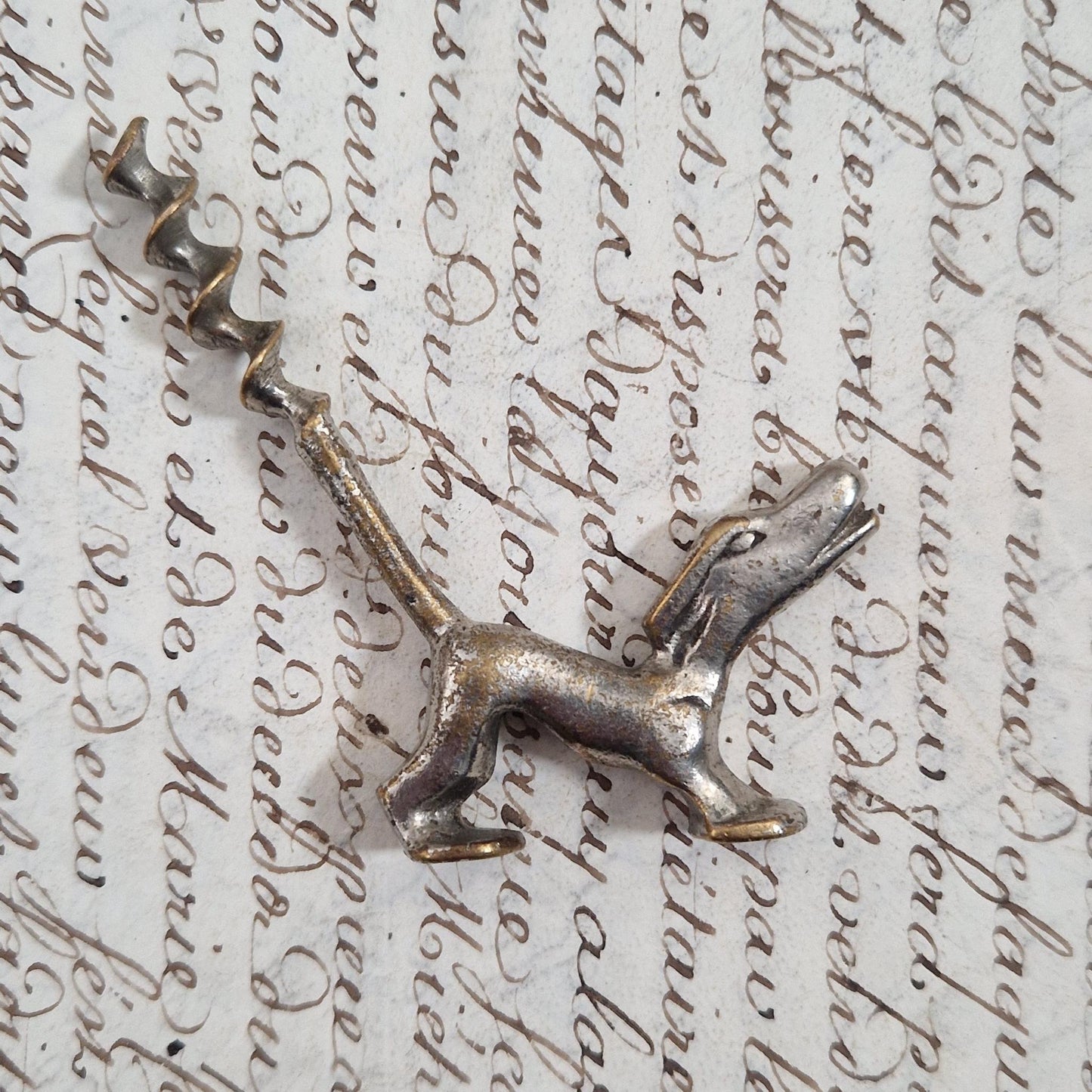 Antique metal corkscrew with a dog motif