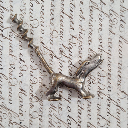 Antique metal corkscrew with a dog motif