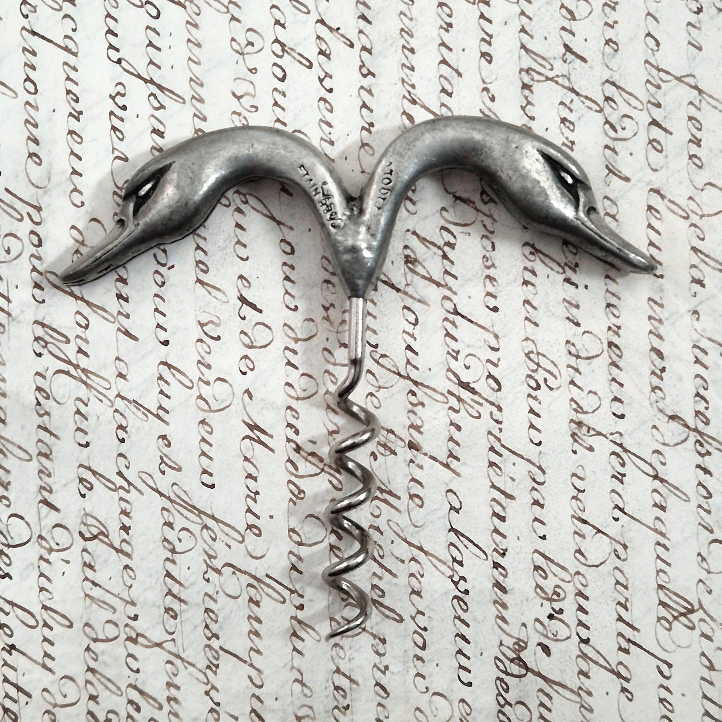 Antique pewter corkscrew decorated with swans