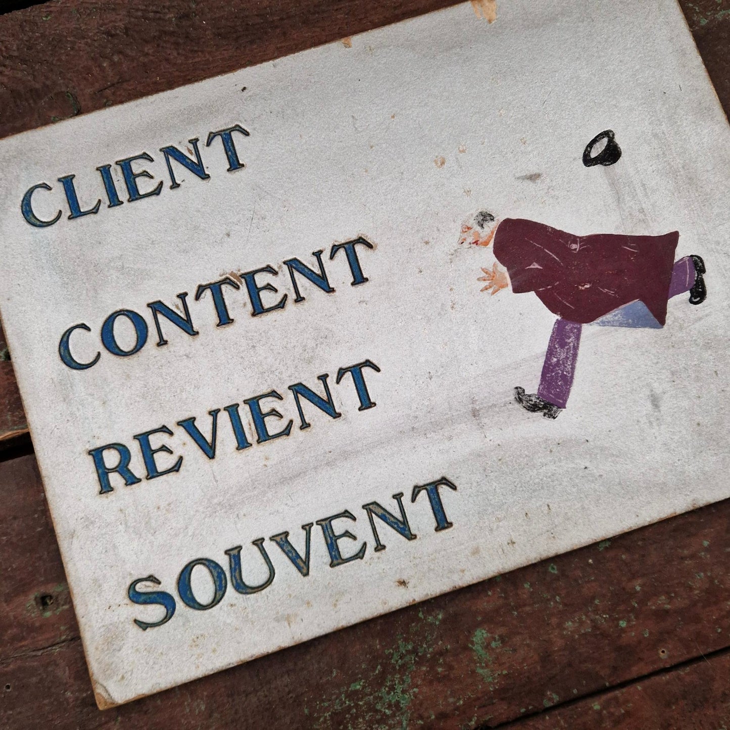 Old sign: "A satisfied customer often returns"