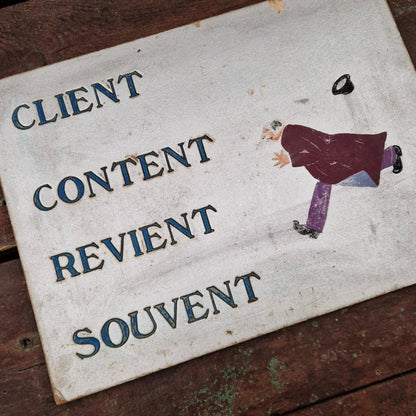 Old sign: "A satisfied customer often returns"
