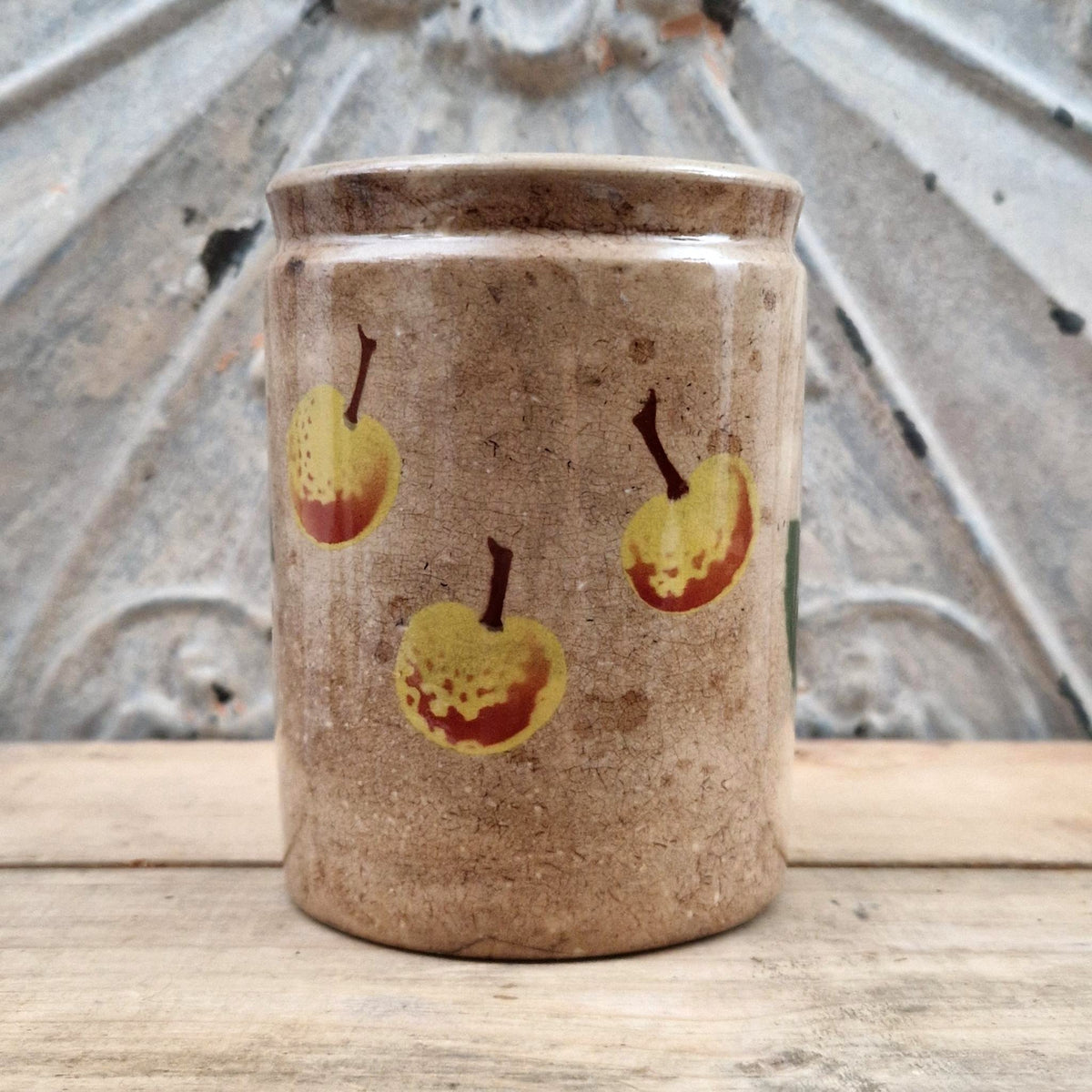 Old jam jar with apple or peach decoration