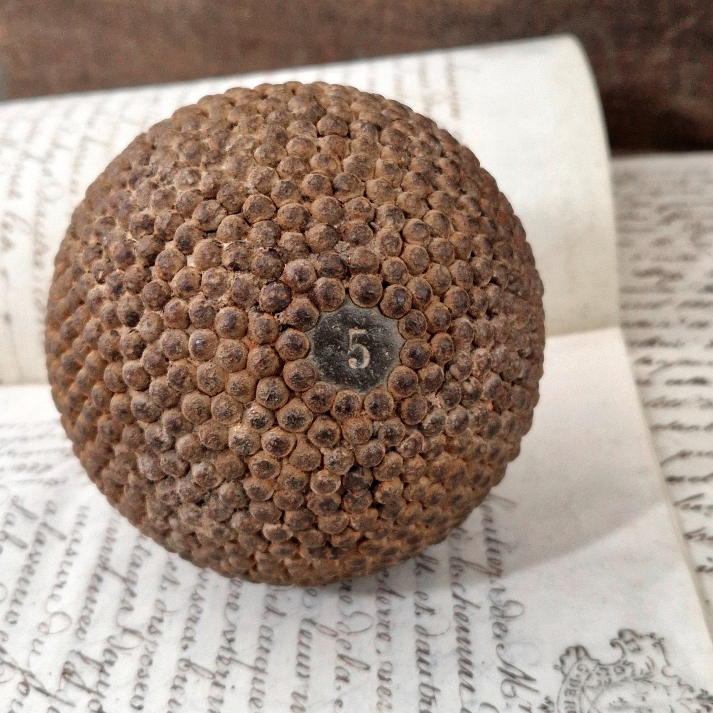 antique wooden nailed ball number 5