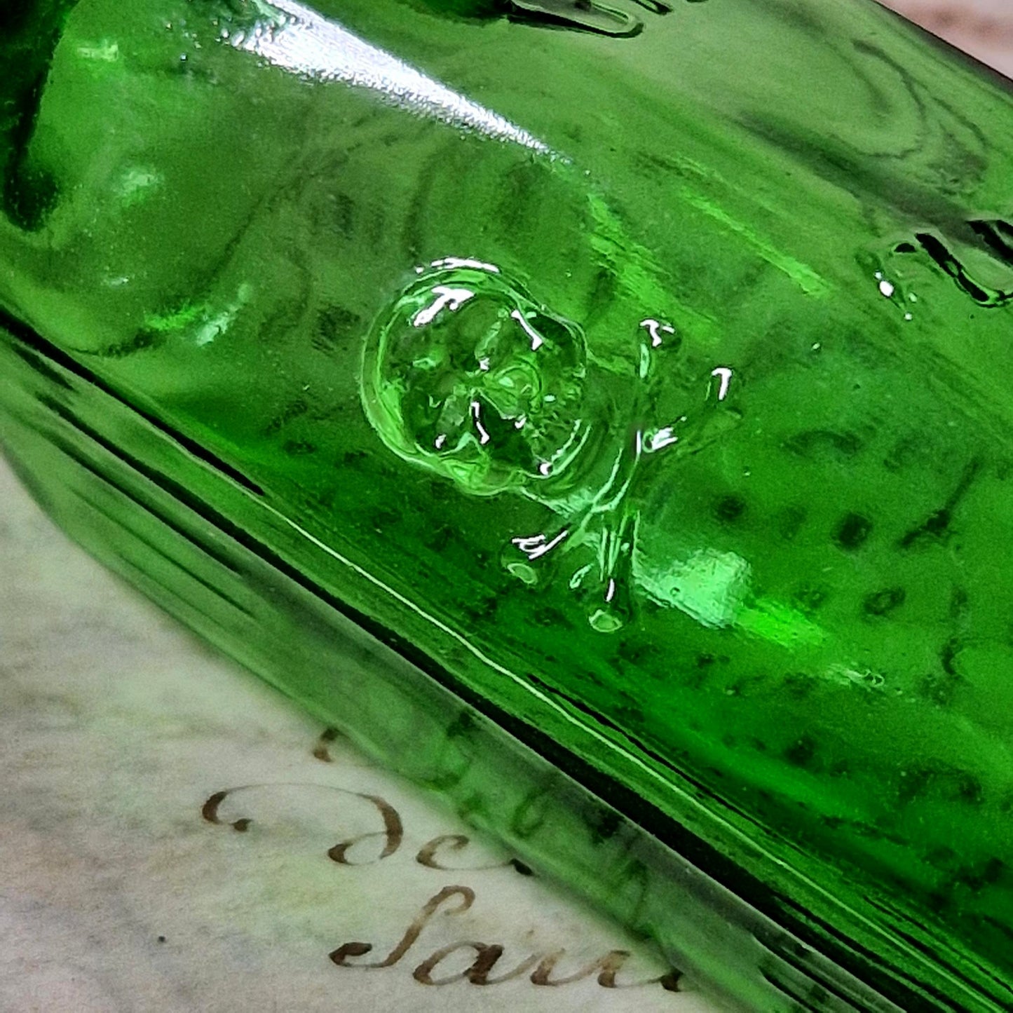 green glass skull poison flask