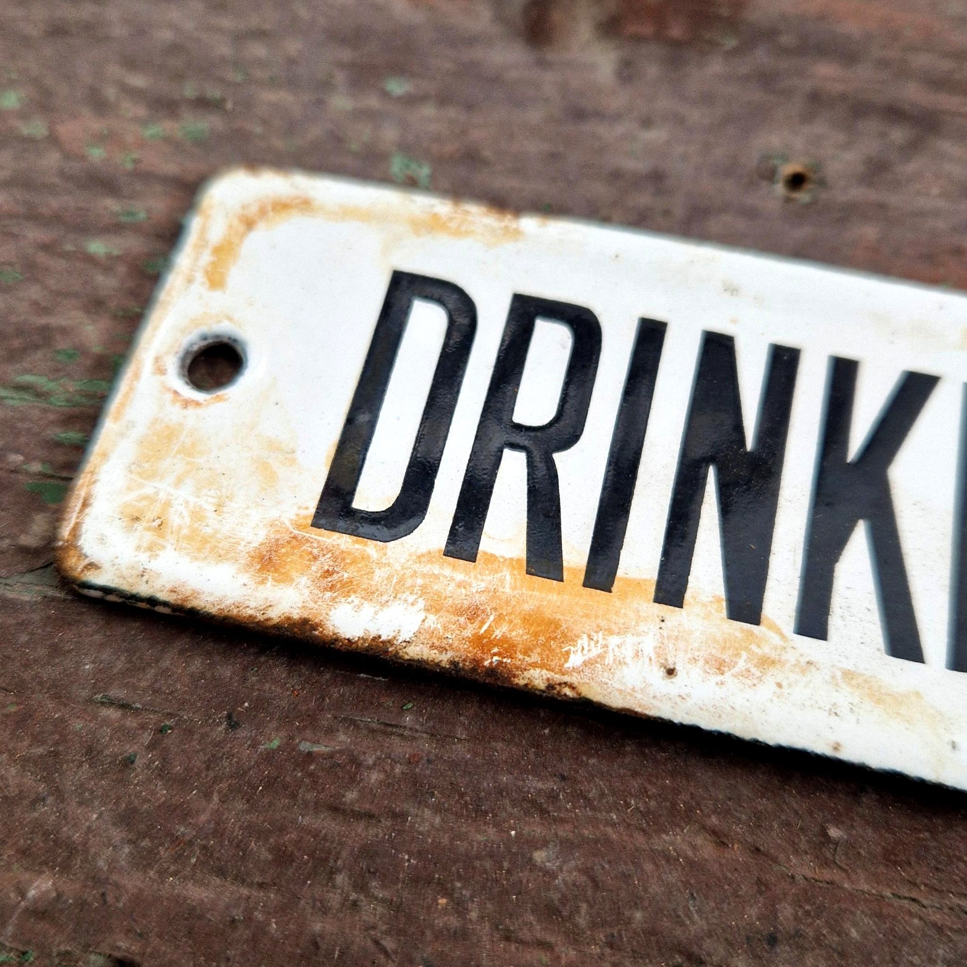 old enamel sign drinking water